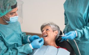 man dentist operating senior woman in dental clini 2021 07 06 18 14 59 utc 1